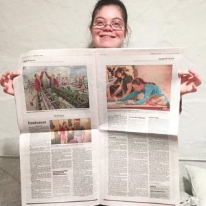 Julia proudly showing off a copy of the 12/2/17 Philadelphia Inquirer featuring Dance Happy.